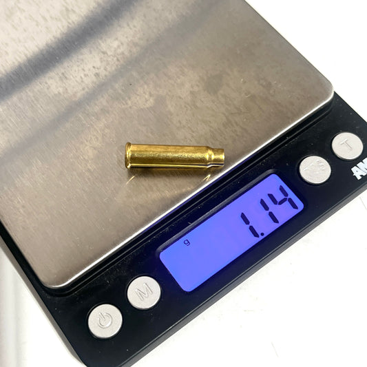 Single empty brass 17 HMR shell on a digital scale reading 1.14 grams