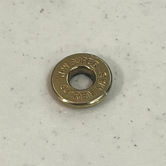 Close-up of a 44 Remington Magnum brass bullet slice headstamp reading W-W Super 44 Rem Mag
