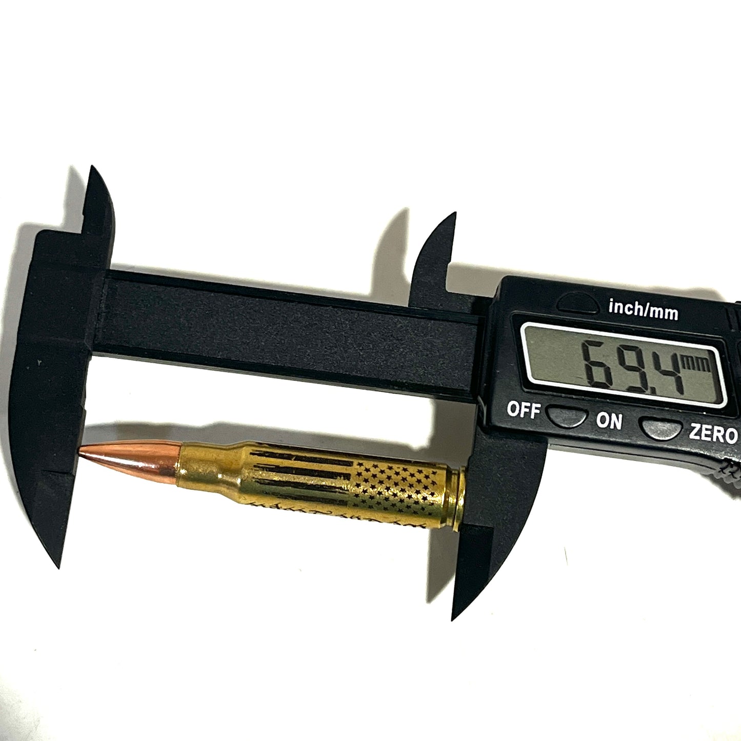 Digital caliper measuring a .308 Winchester dummy round showing 69.4 mm length for precision display specs.