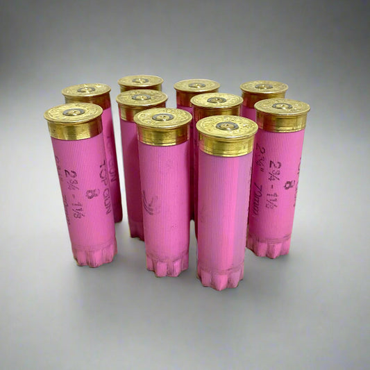 Ten pink Federal 12 gauge shotgun shell hulls standing upright showing brass headstamps