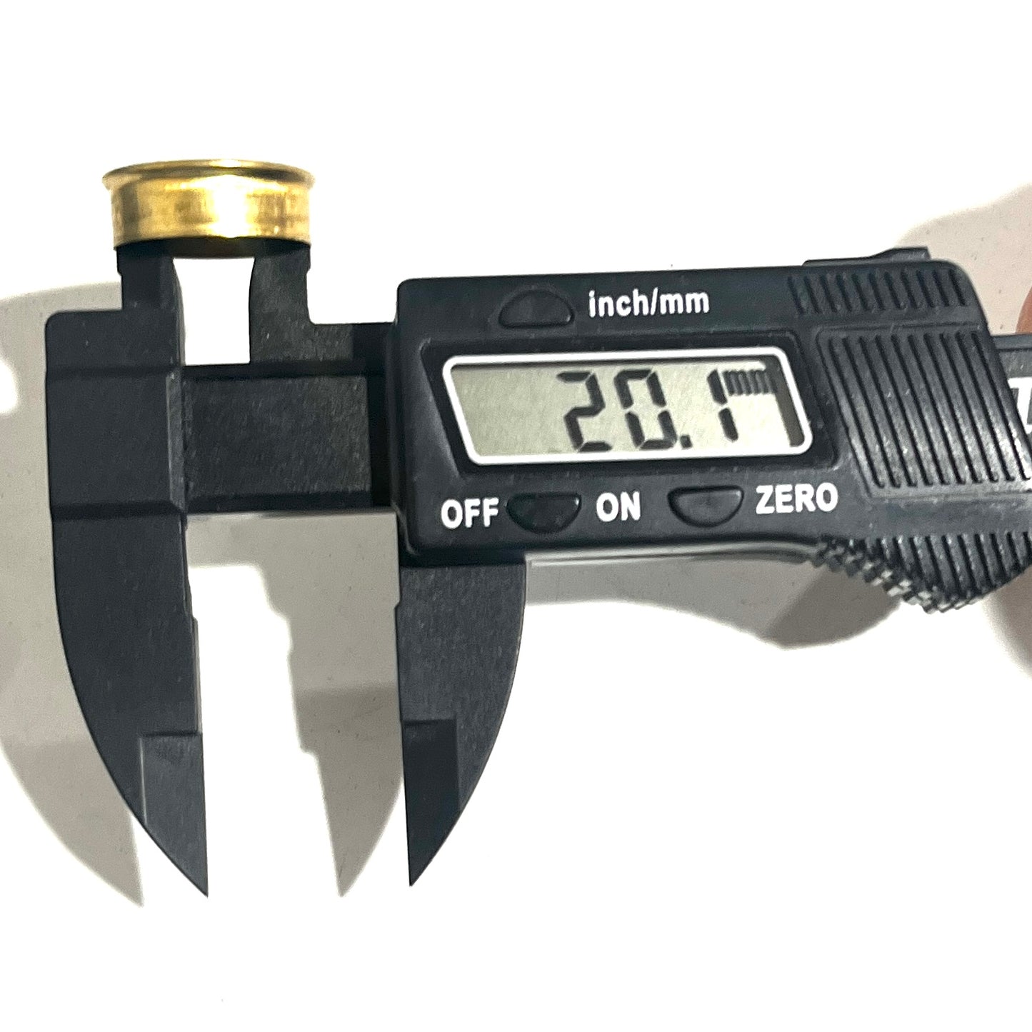 Gold Fiocchi 12 gauge shell bottom inside diameter measured at an angle with a caliper reading 20.1 millimeters.