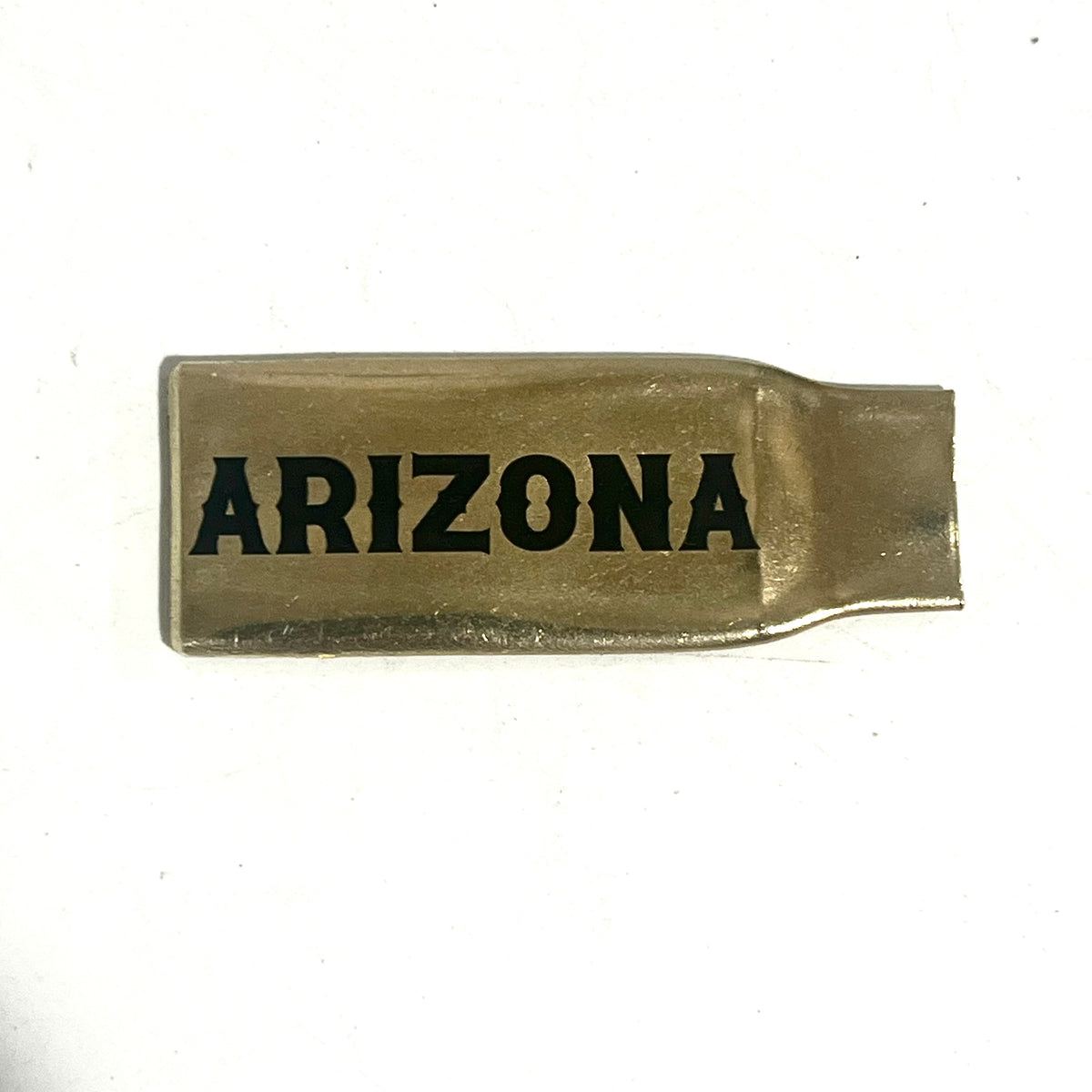 Flattened brass .308 casing engraved with Arizona in black lettering on a white background