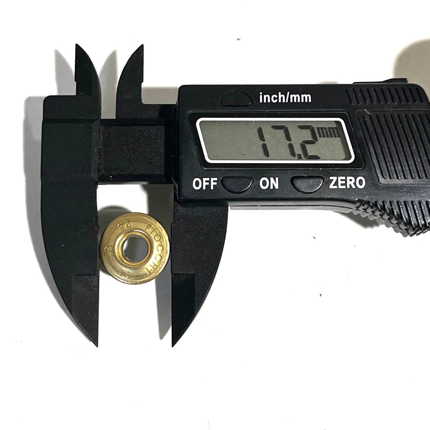 Digital caliper measuring the diameter of a Fiocchi 28 gauge shotgun shell slice at 17.2 mm