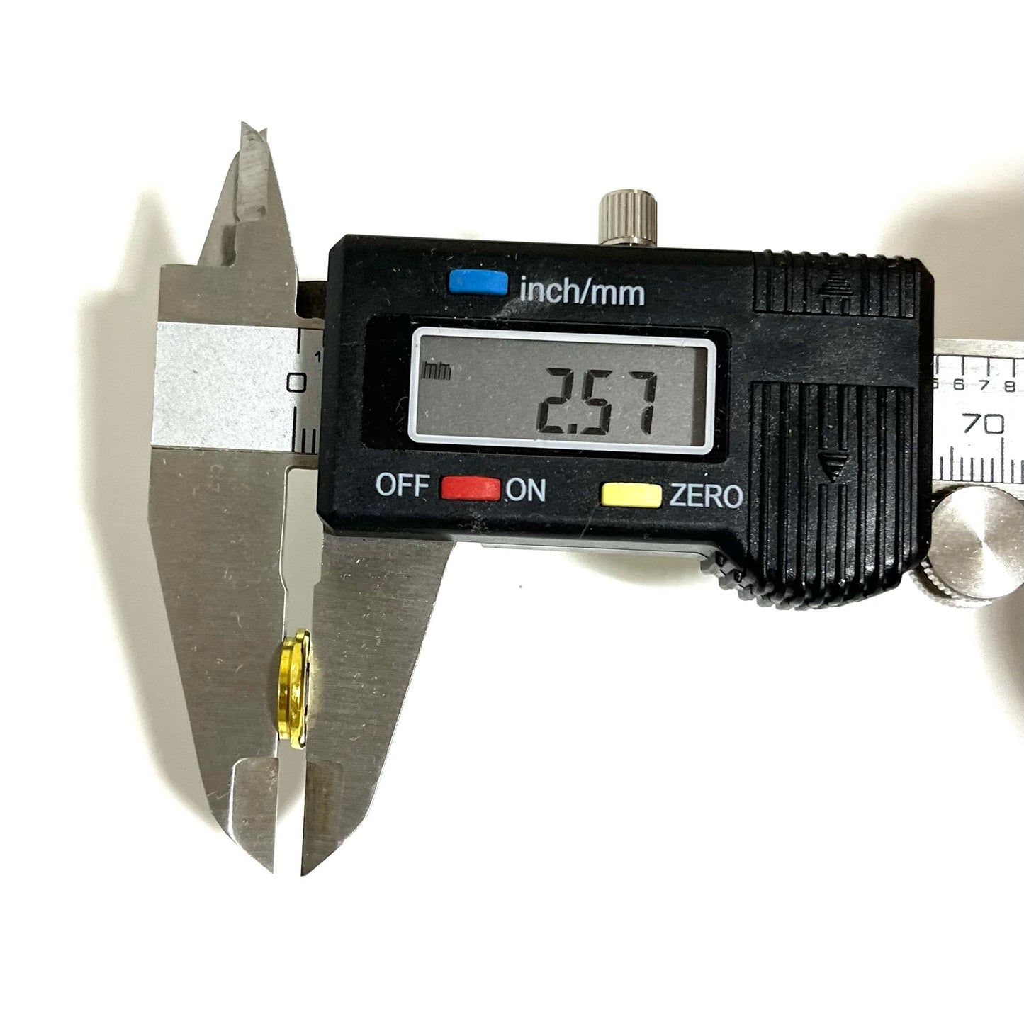 Brass 308 casing slice edge measured with a digital caliper reading 2.57mm on white background