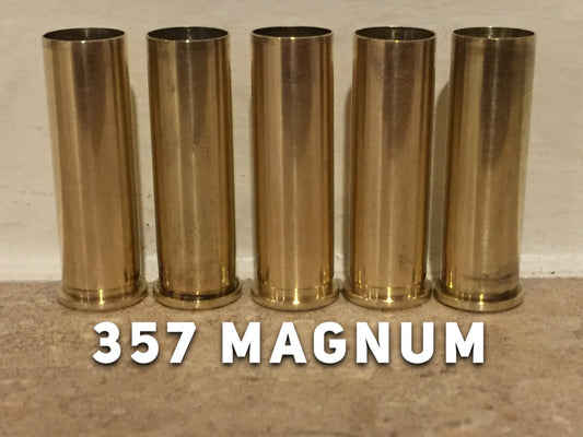 Five polished 357 Magnum brass shell casings lined up side by side with 357 MAGNUM text across the bottom.