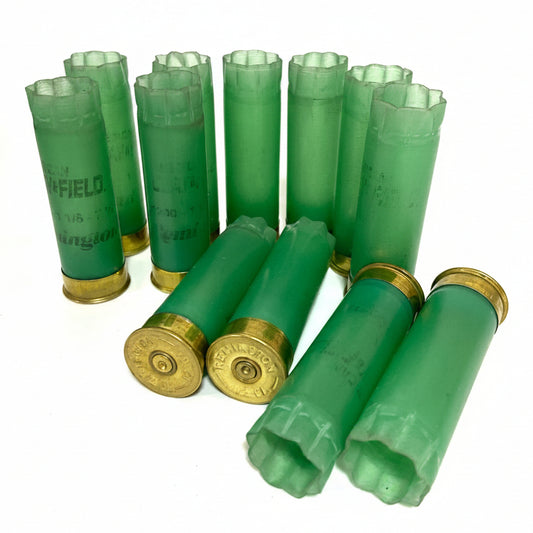 Light Green Remington Clay Field Hulls Standing With Headstamp Showing