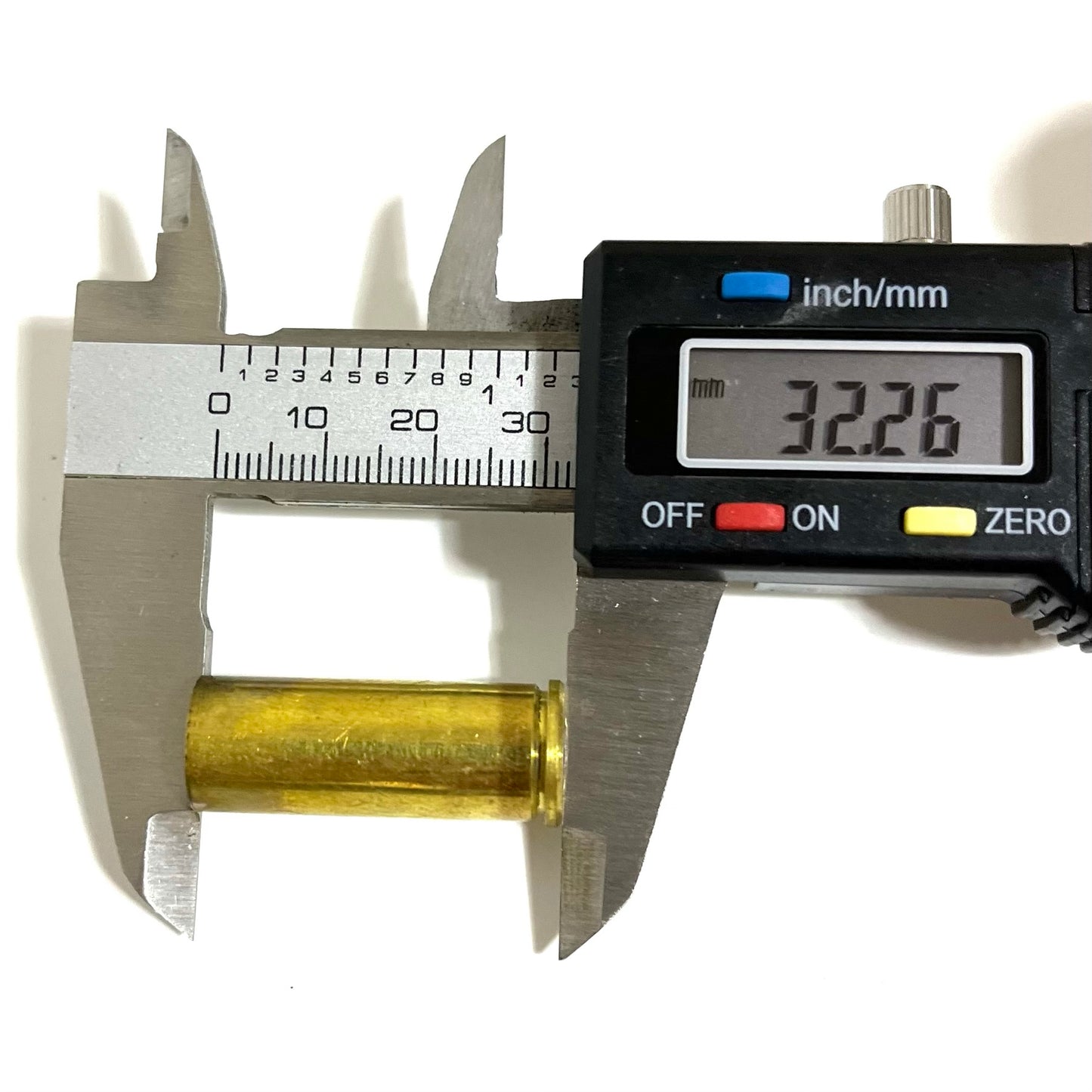 Digital caliper measuring the height of a gold .45 Colt brass casing, reading 32.26mm