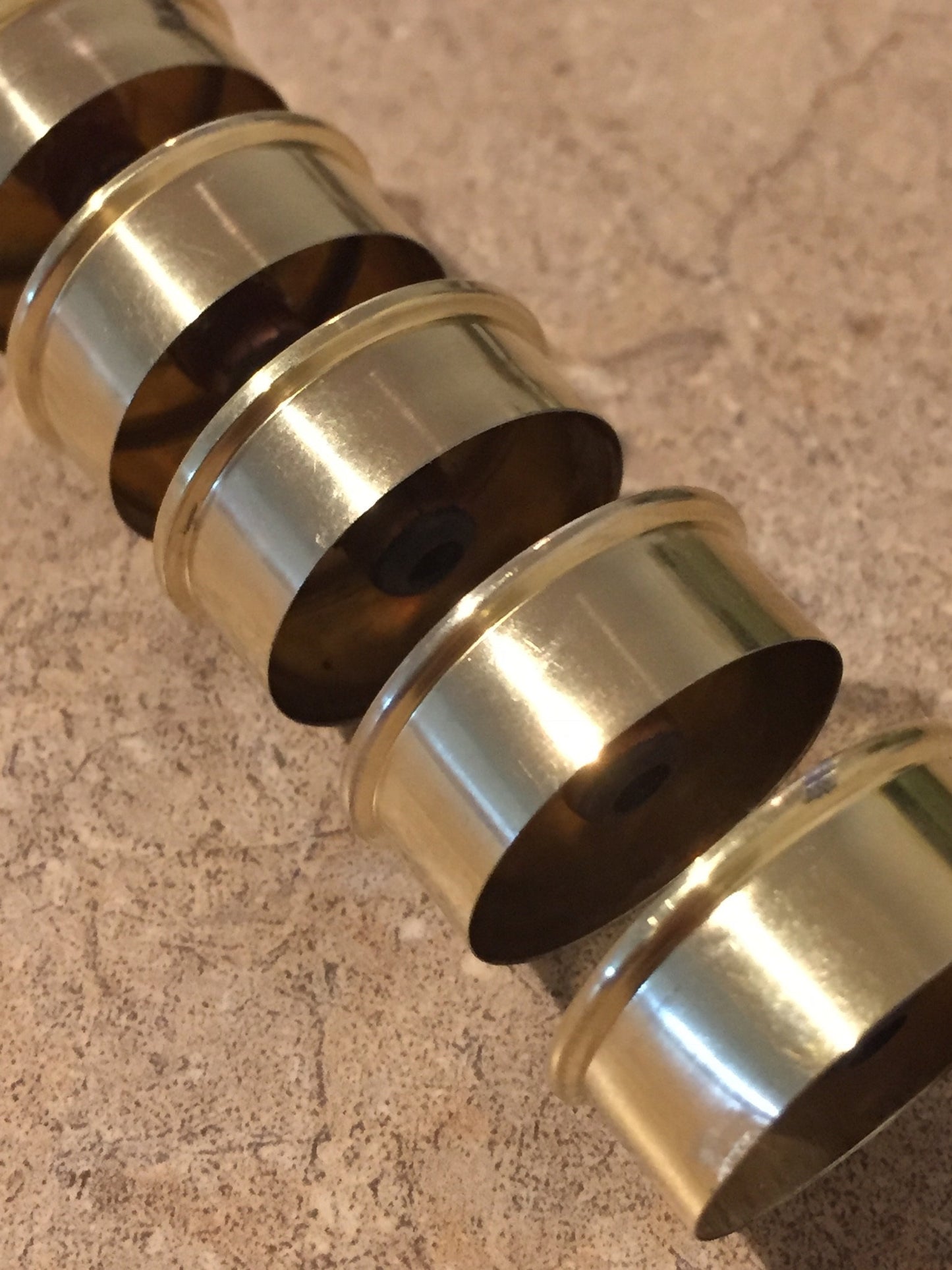 Closeup of gold-toned Remington Peters shotgun shell hulls stacked and nested together