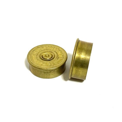Two gold 12 gauge shotgun shell bottoms on white background showing flat base and side profile for crafts.
