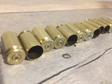 Load image into Gallery viewer, Spent Drilled Brass Bullet Casings
