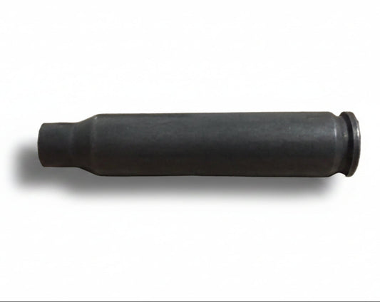 A single used gray steel cartridge lies on its side against a plain background.