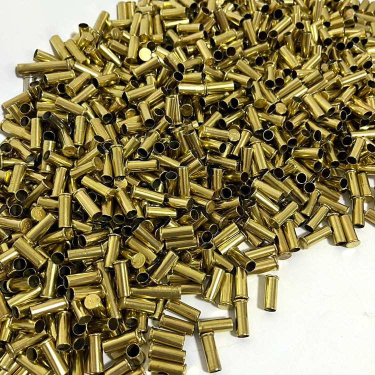 A large pile of authentic empty .22 caliber brass shells showing visible fired wear and spent rim strikes.