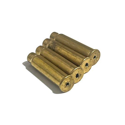 4 empty brass 17 HMR shells with drilled holes viewed from the base on a white background
