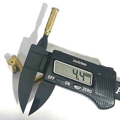 Digital caliper measuring the case mouth hole diameter of a brass 17 HMR shell at 4.4 mm, with a second shell nearby