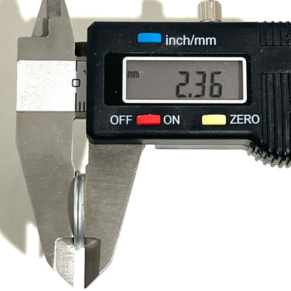 Digital caliper measuring a Winchester 20 GA shotgun shell slice at 2.36 mm thick