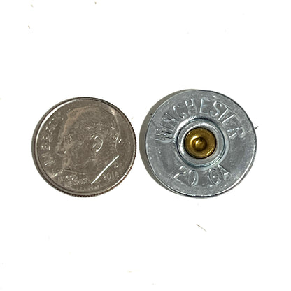 Winchester 20-gauge shotgun shell bullet slice next to a dime for size comparison and reference