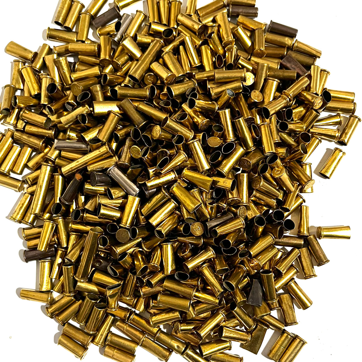 Large pile of loose brass shell casings viewed from above showing dents and dings