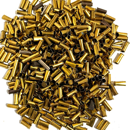 Large pile of loose brass shell casings viewed from above showing dents and dings