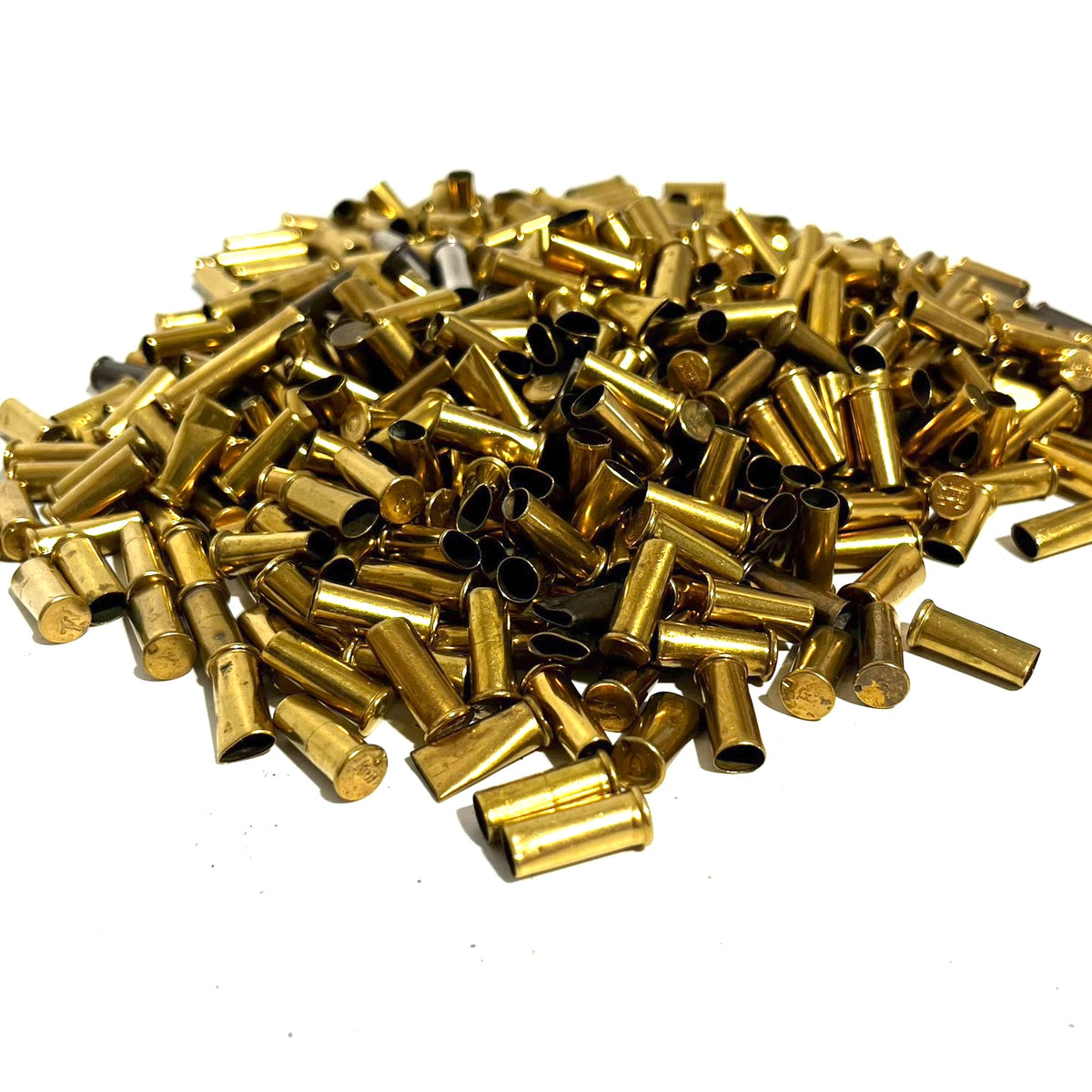 Large pile of loose brass shell casings with some standing on end