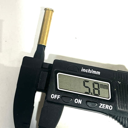 Digital caliper measuring the diameter of a brass 22 caliber WMR shell showing 5.8 mm