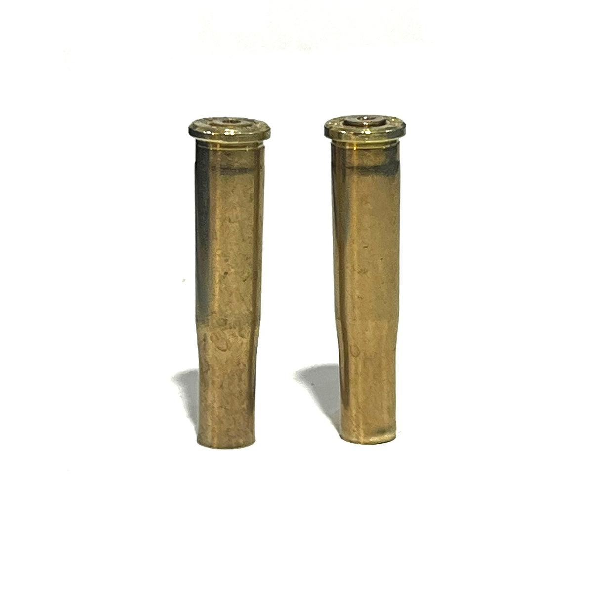 2 brass .22 Hornet shell casings standing upright on a white background