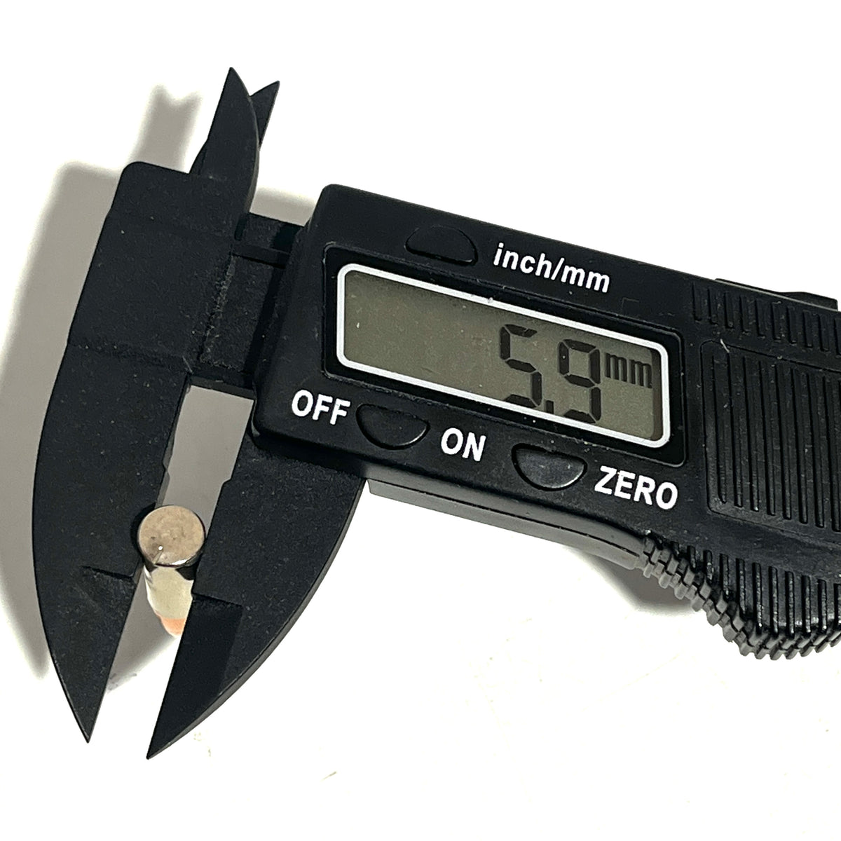 Digital caliper measuring a .22 caliber dummy round's bullet diameter at 5.9 millimeters
