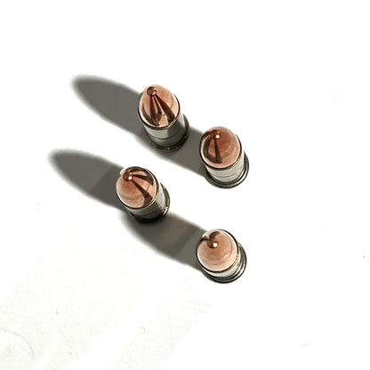 4 .22 caliber nickel dummy rounds viewed from above showing copper bullet tips with drilled dimples