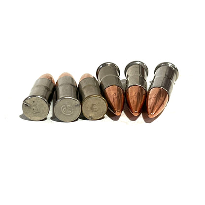 6 .22 caliber nickel dummy rounds lying in a row on a white background, 3 with headstamps visible
