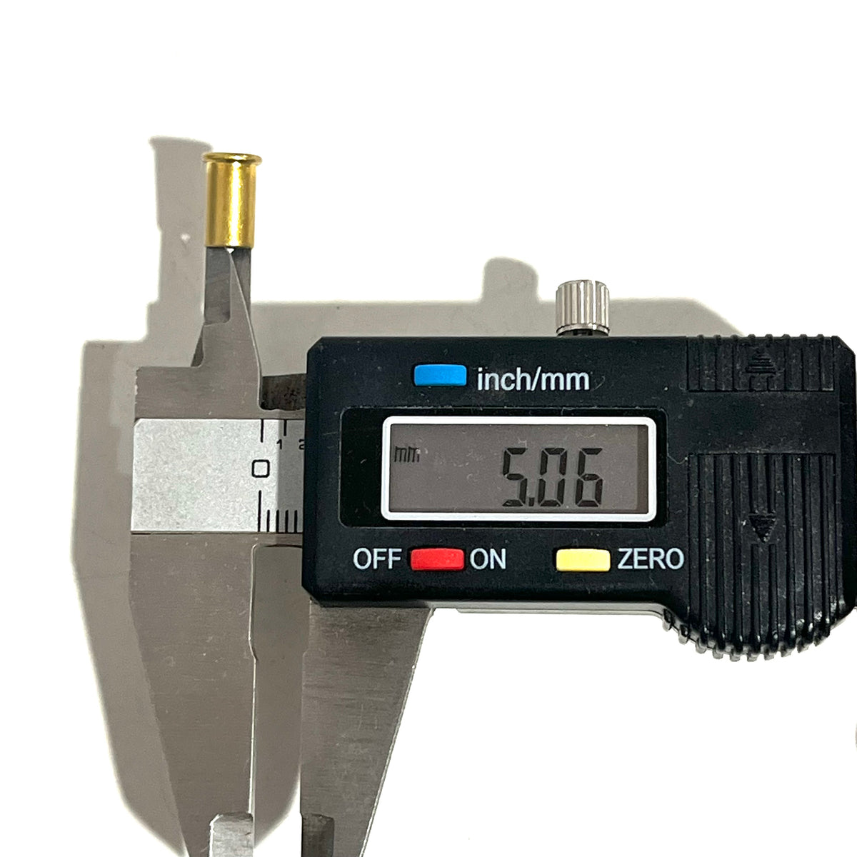 Digital caliper measuring the diameter of a brass shell casing showing 5.06 mm
