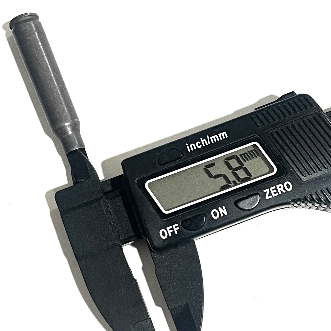 A digital caliper grips an empty gray steel shell's neck, showing a diameter reading of 5.8 mm.
