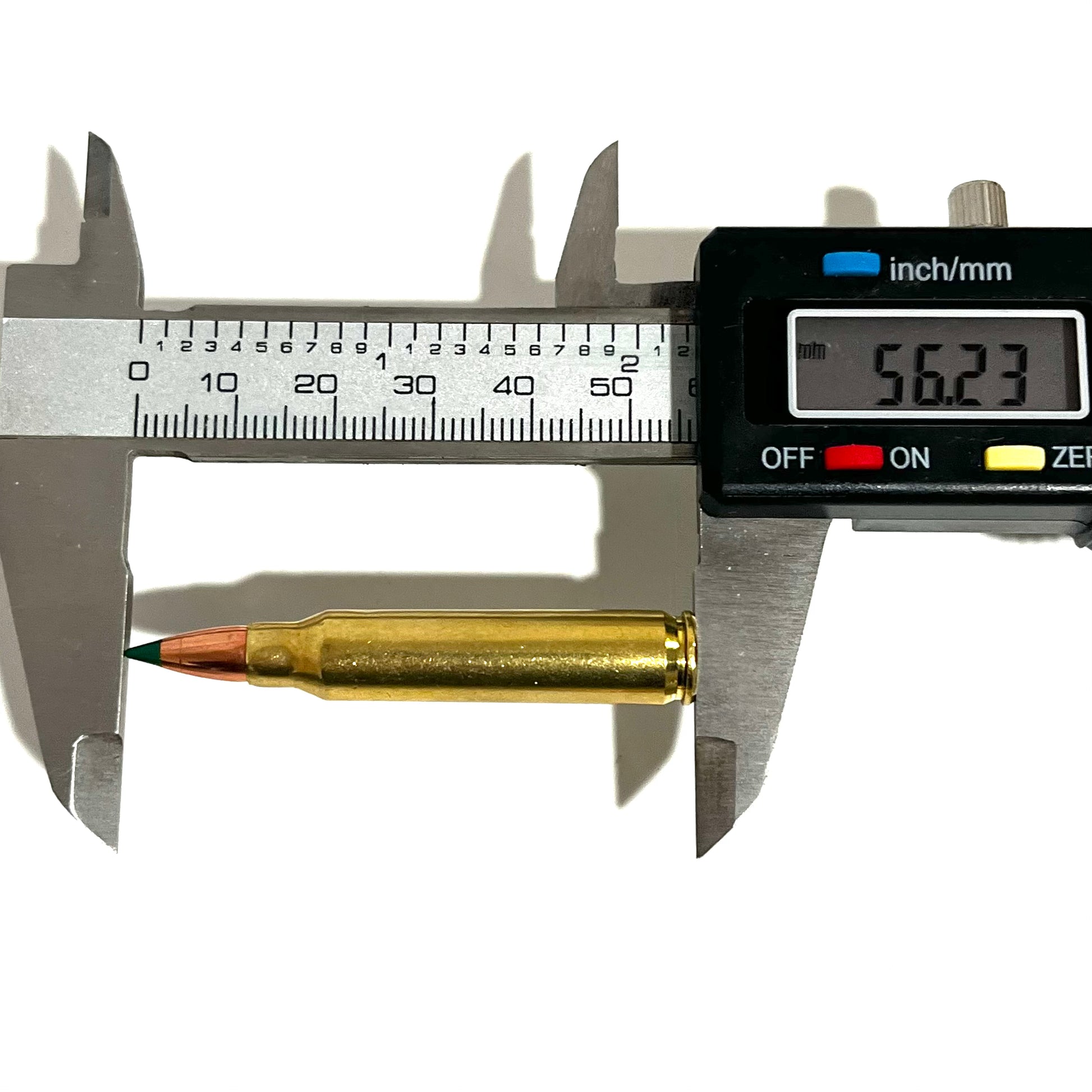 A single brass .223/5.56 dummy round with a green tip being measured lengthwise by a digital caliper showing a reading of 56.23mm.