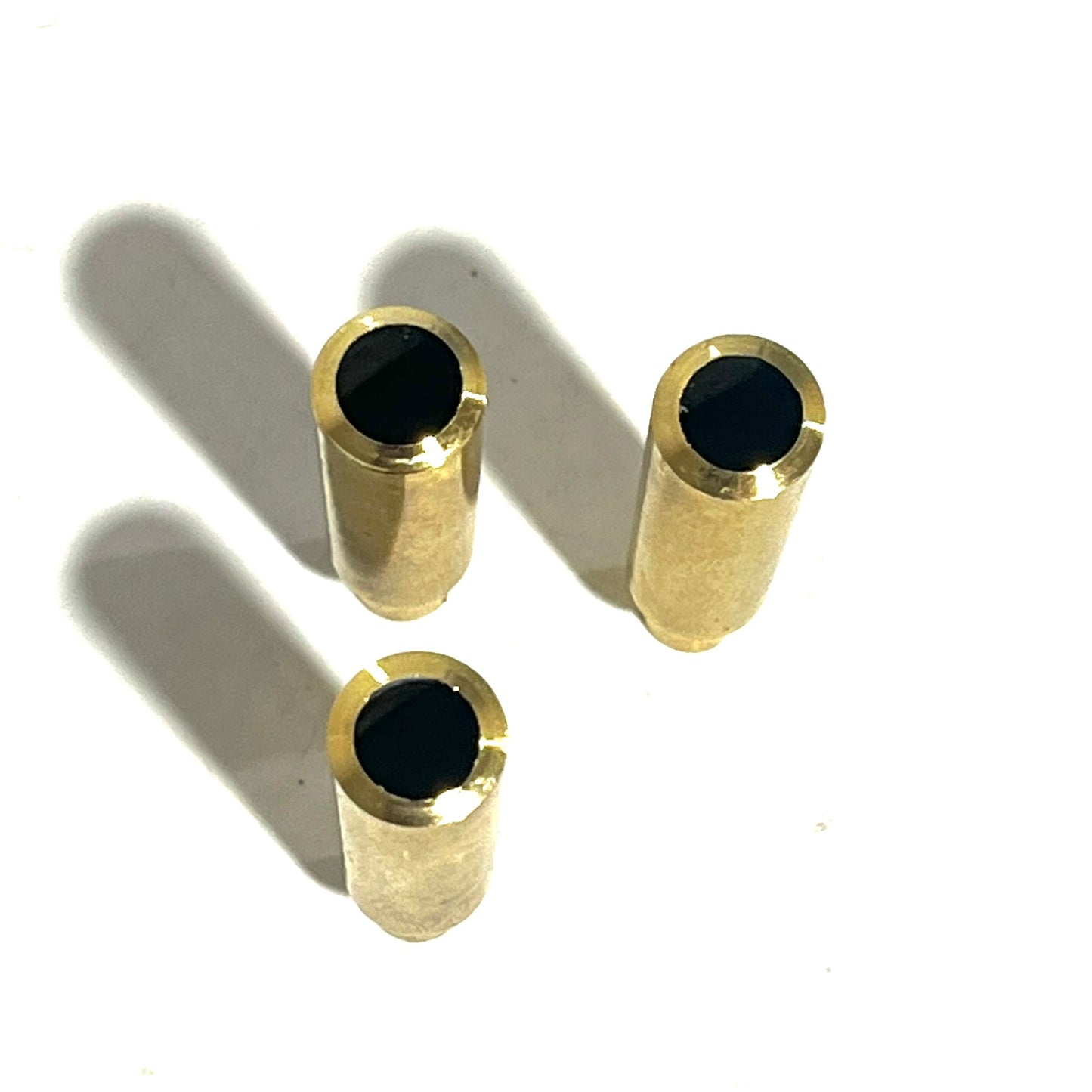 top view of 3 .223 brass cases showing larger cut opening