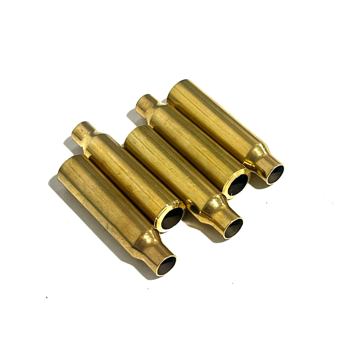 Five .223 brass bullet casing beads arranged in a staggered cluster, showing the open cut ends