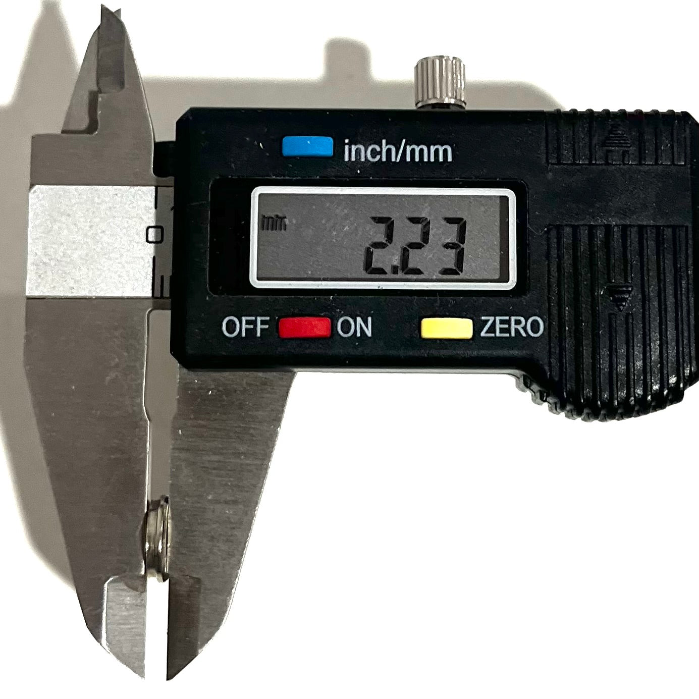 Digital caliper measuring the diameter of a 223 5.56 bullet slice showing 2.23 mm