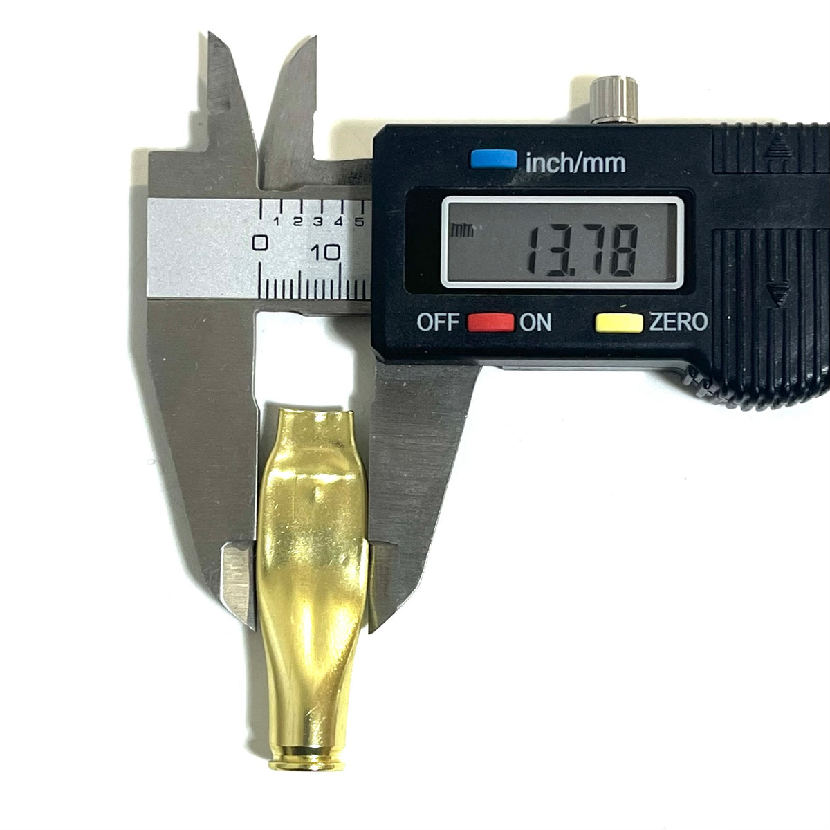 Digital caliper measuring the diameter of a brass .223 casing at 13.78mm