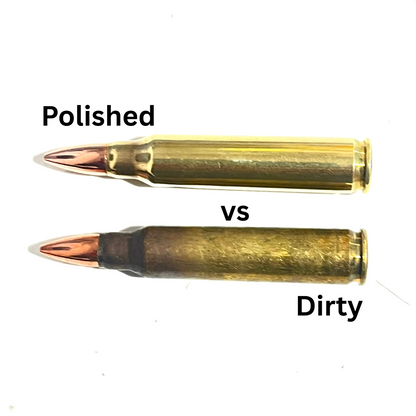 Two 223 raw dummy rounds on a white background, one labeled 'Polished' with a shiny brass casing and copper-toned tip, and one labeled 'Dirty' with a darker, worn brass casing and copper-toned tip, with 'vs' between them for comparison.