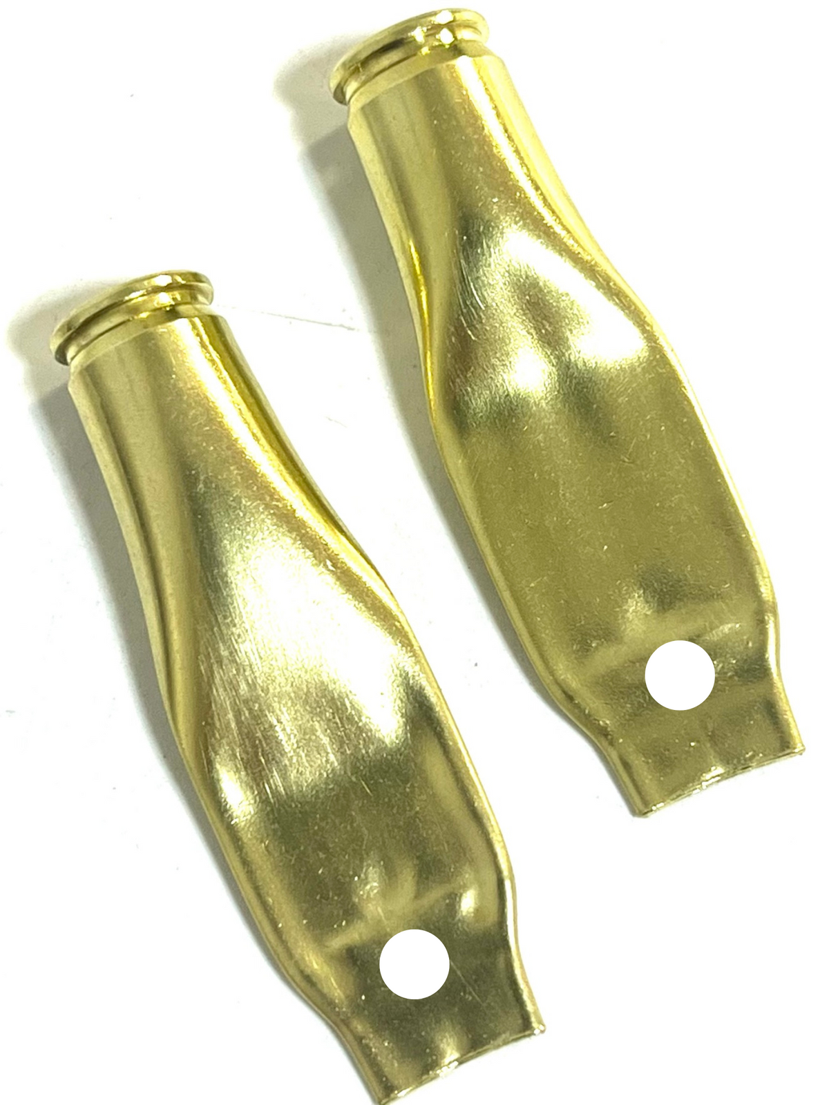 Two flattened brass .223 casings with a punched hole near the base, curved shape, white background