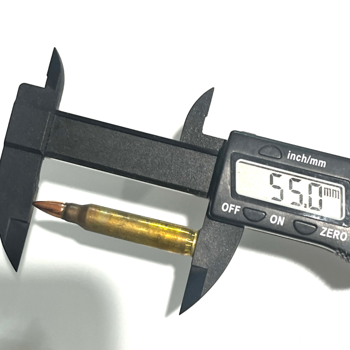 Digital caliper measuring the length of a dirty .223 dummy round at 55mm