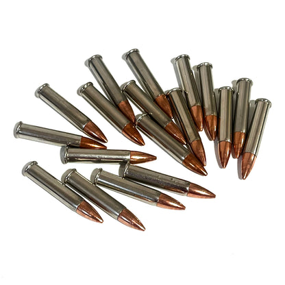 15 .22 Magnum nickel dummy rounds with copper bullets fanned out on white background
