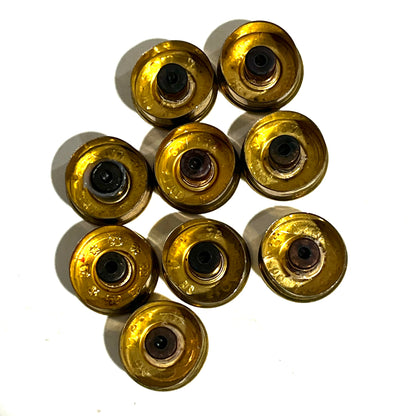 Direct overhead view of ten gold brass 28 gauge Fiocchi shotgun shell bottom side with spent primers on a white background