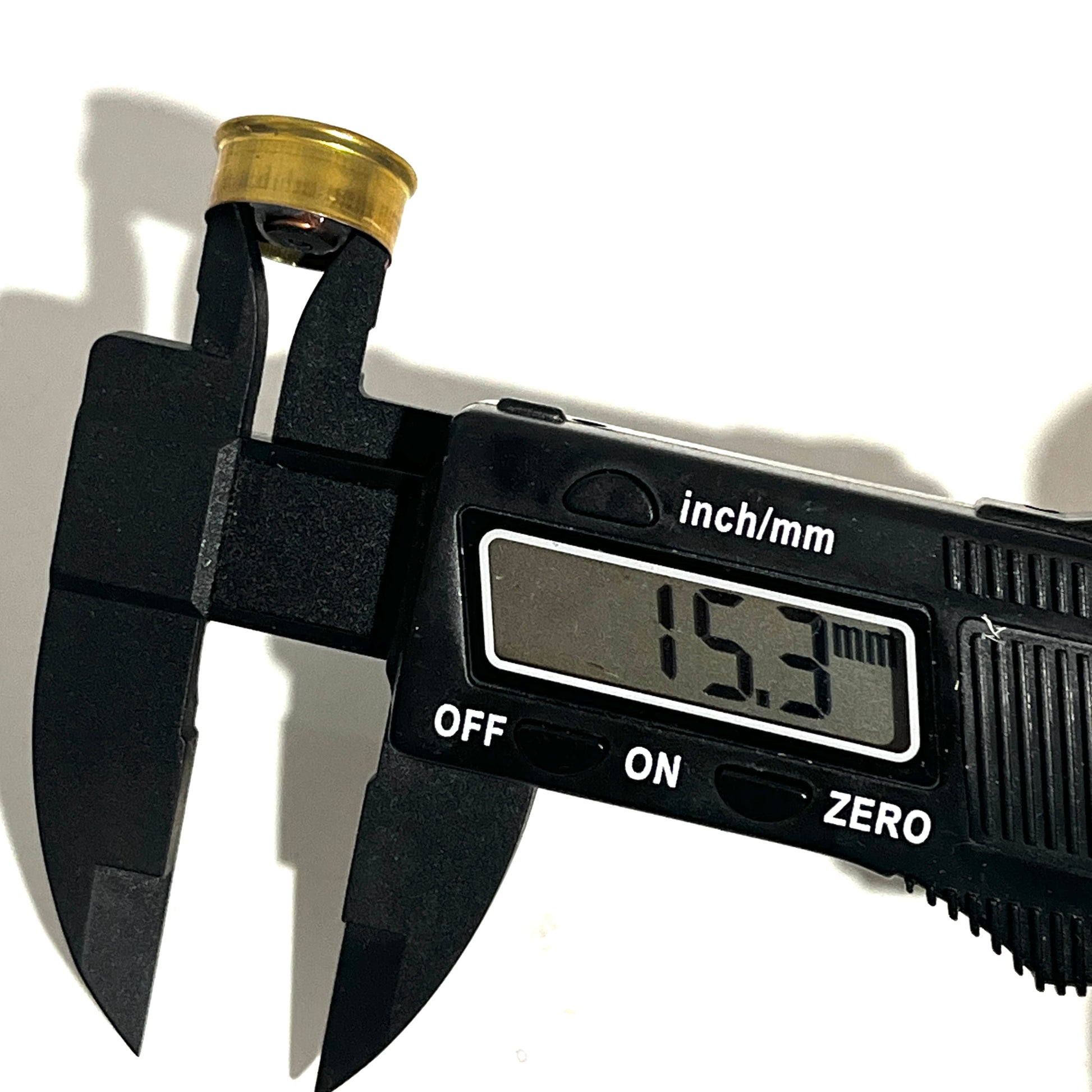 Digital caliper measuring a gold brass 28 gauge Fiocchi headstamp showing 15.3 mm on the display.