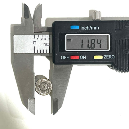 Digital caliper measuring the diameter of a nickel 30-06 bullet slice showing 11.84 mm