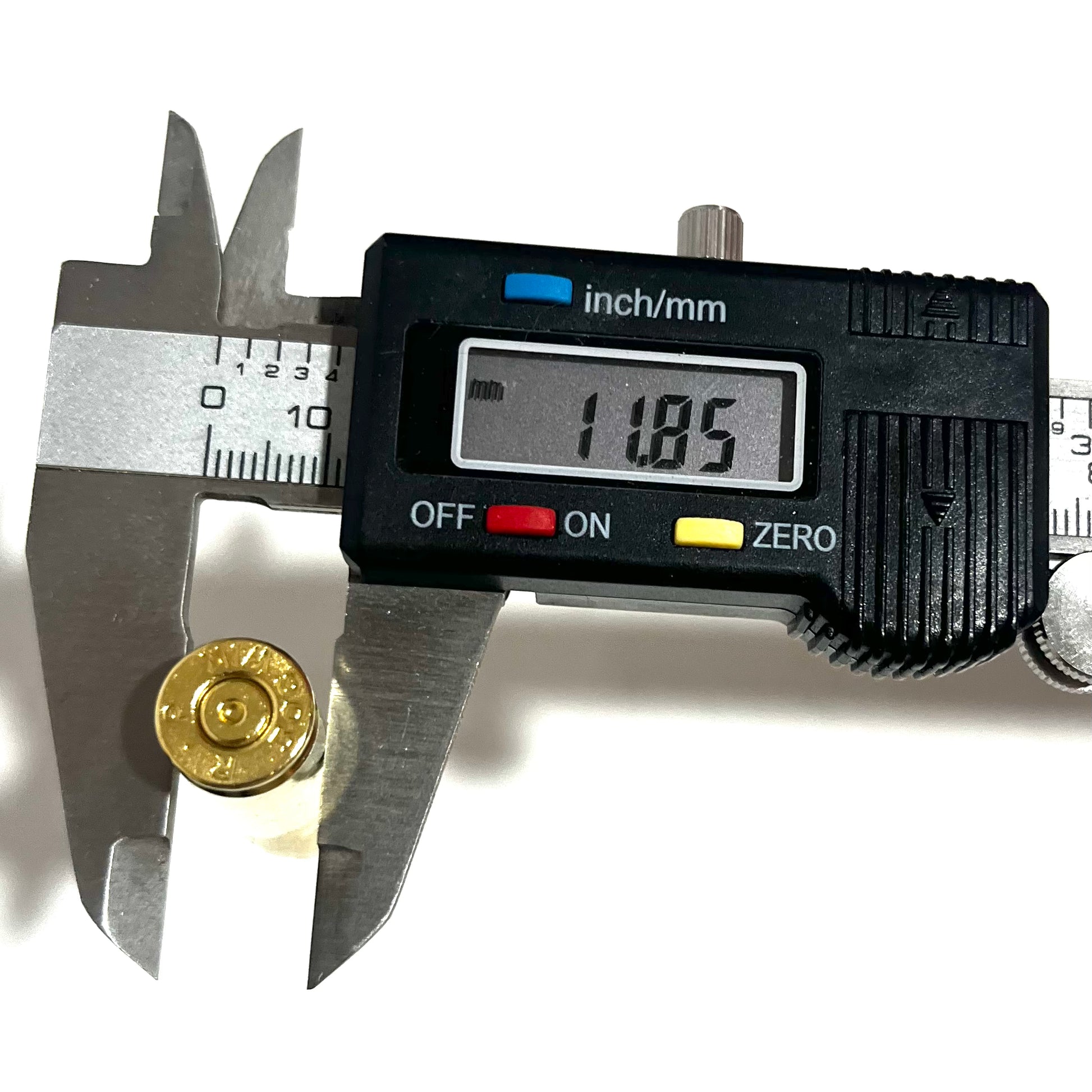 Digital caliper measuring the base rim diameter of a gold 308 WIN brass casing, displaying a readout of 11.85 mm.