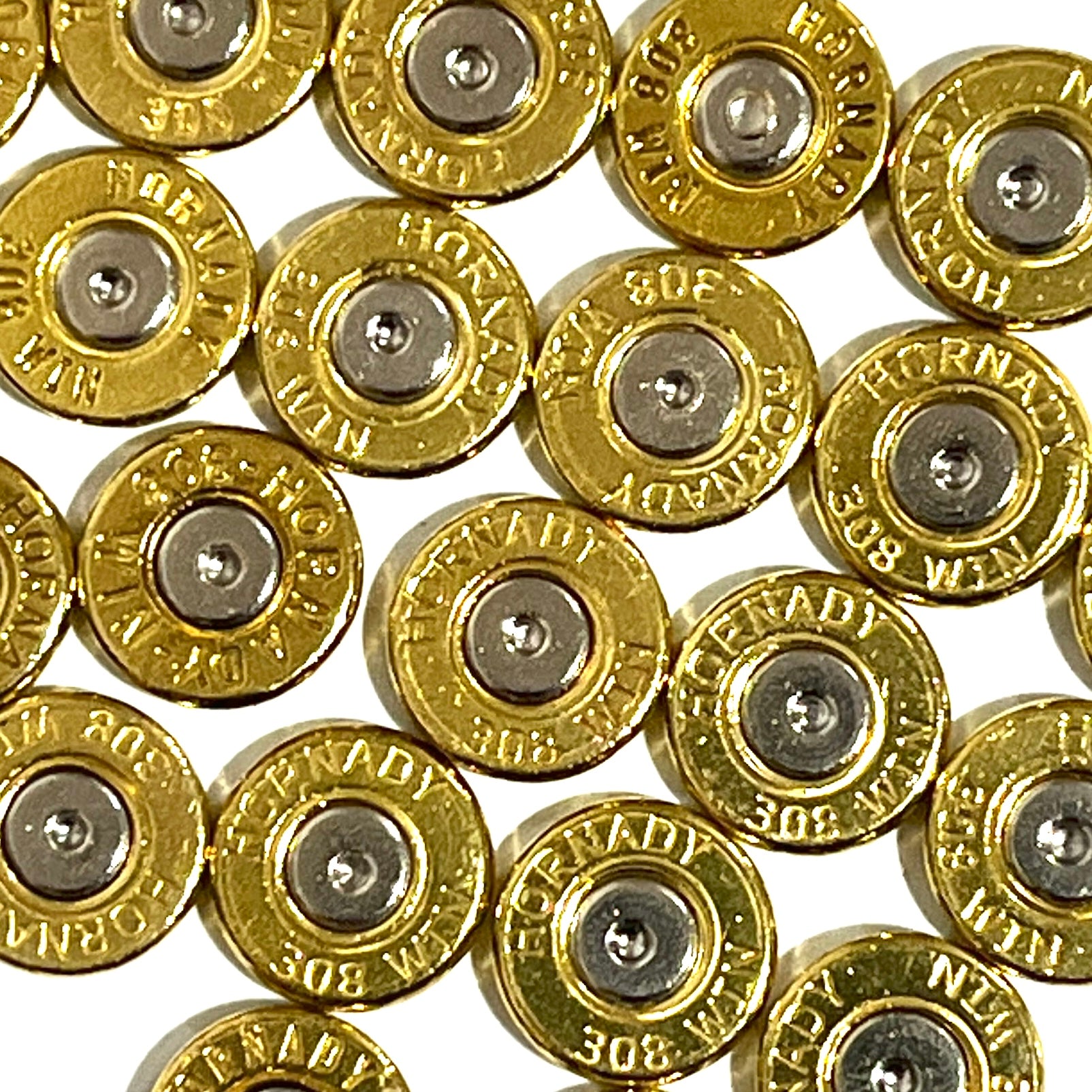 Close-up pile of gold 308 Hornady brass bullet slices showing silver primers and headstamps