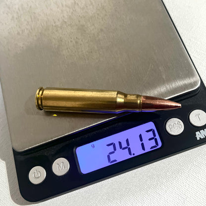 Single brass .308 prop round for film on a digital scale reading 24.13mm