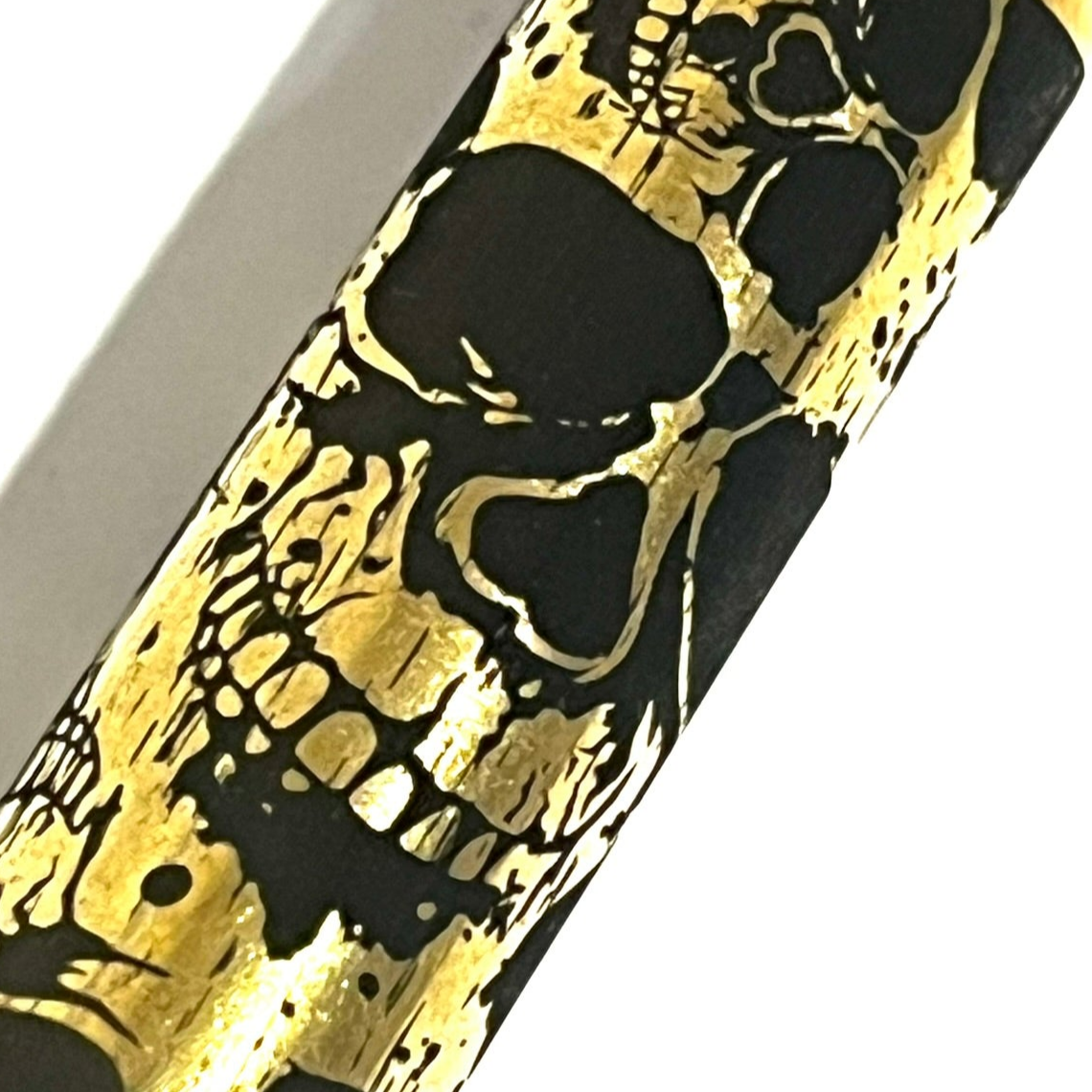 Single 308 WIN brass casing with detailed laser-engraved skull artwork along the side for craft projects.
