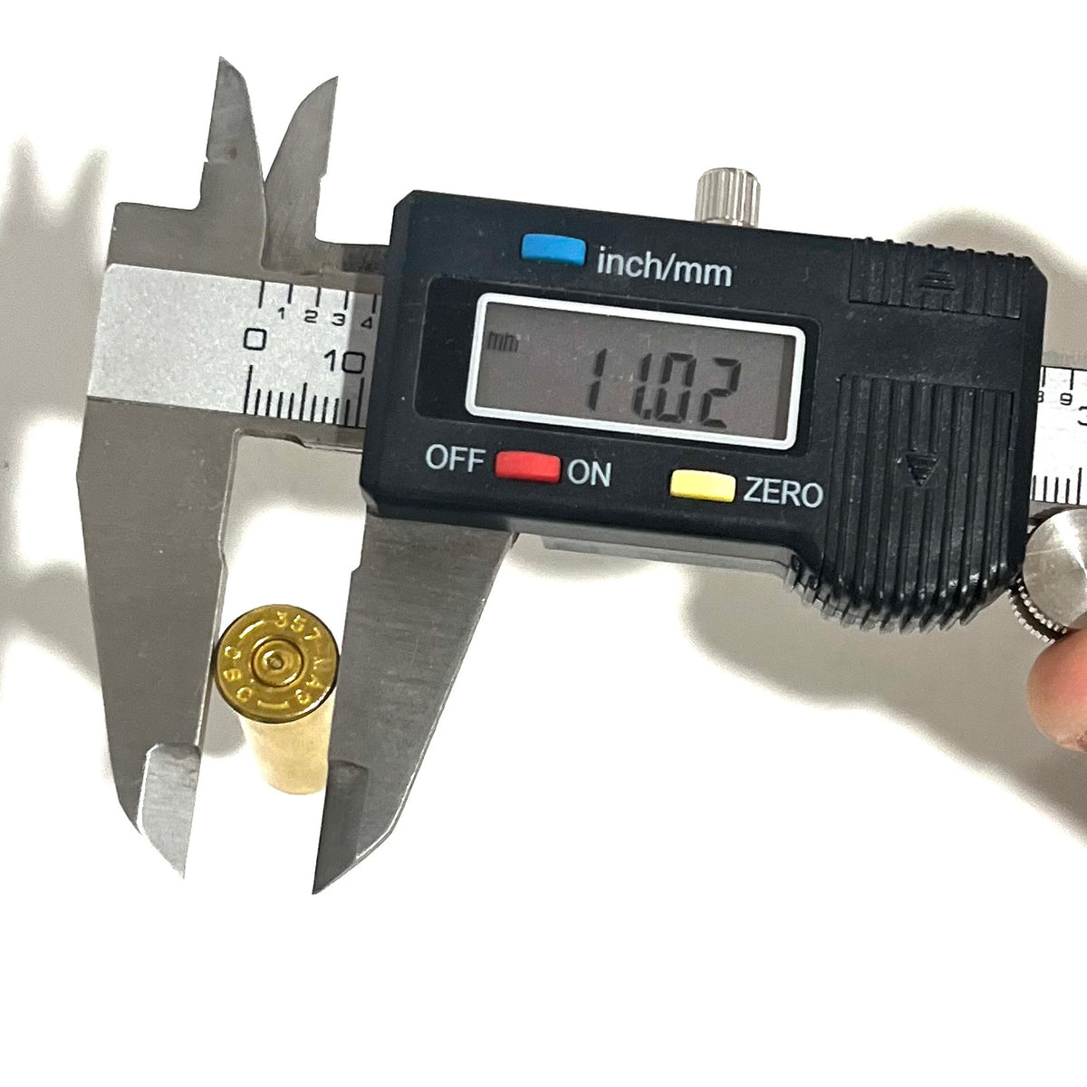 Digital caliper measuring a 357 Magnum brass case length at 11.02 mm