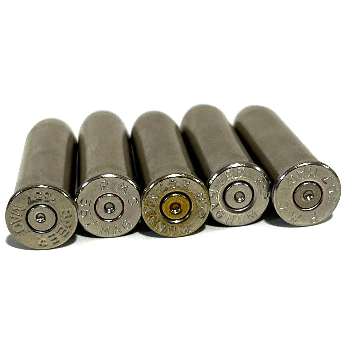 Five nickel 357 Magnum dummy round casings viewed base-up showing headstamps on a white background