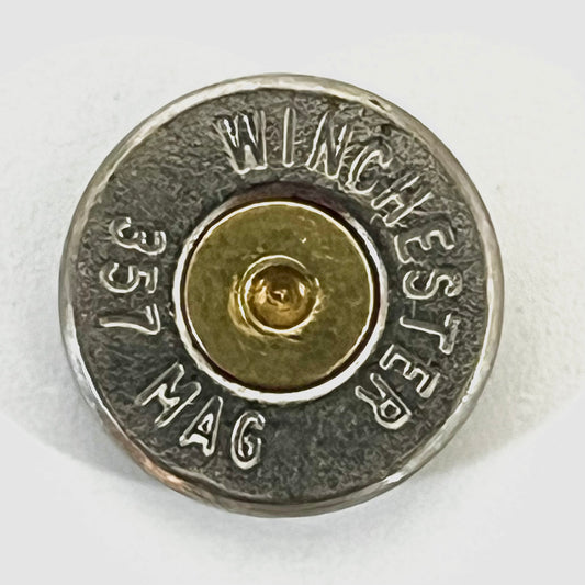 Single 357 Magnum nickel bullet slice with WINCHESTER 357 MAG headstamp and gold primer center on white background