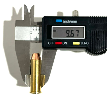 A digital caliper measuring the case diameter of a single .38 Special brass inert cartridge, displaying an exact measurement of 9.67 mm.